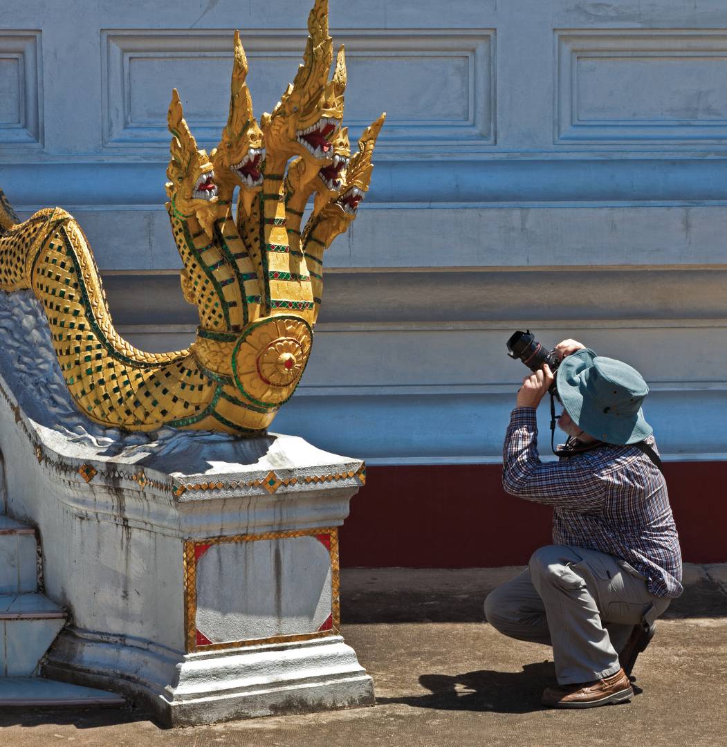 Photographer capturing the History and art at a temple in Luang Prabang | <i>Peter Walton</i>