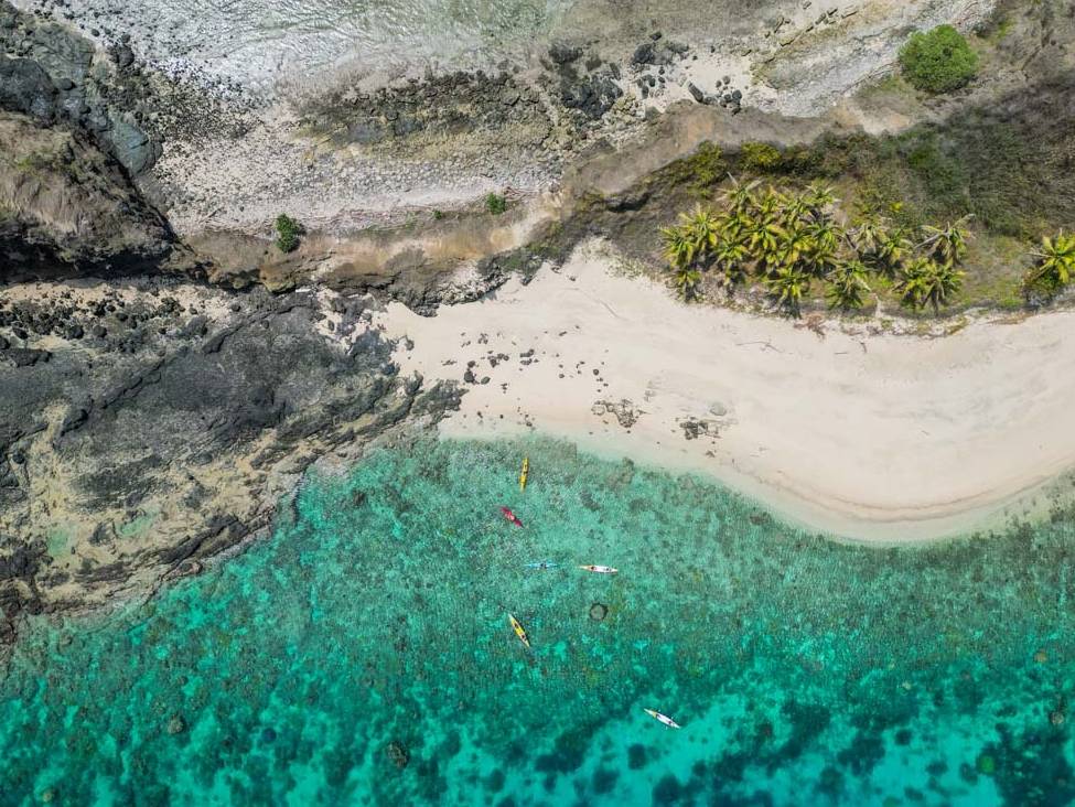 Happy kayakers enjoying paddling the remote Yasawa Islands