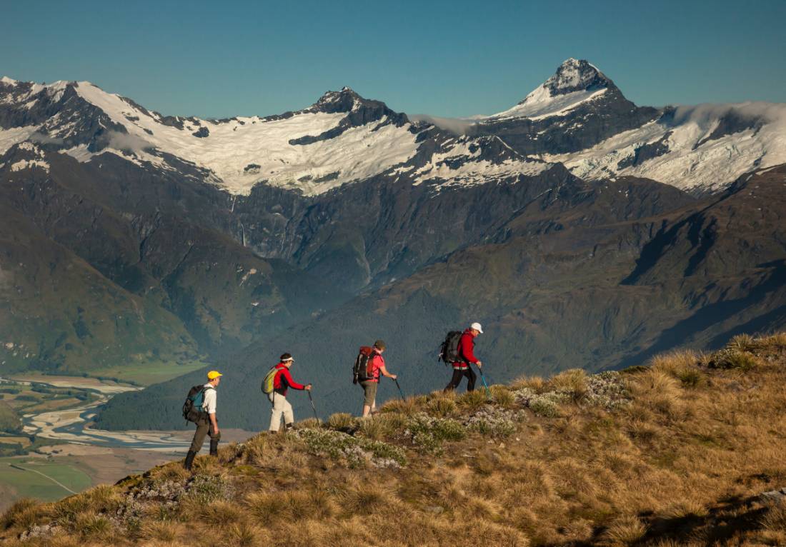 Trekkers on Buchanan peak with Mount Aspiring behind, walking above Matukituki valley, near Lake Wanaka | <i>Colin Monteath</i>