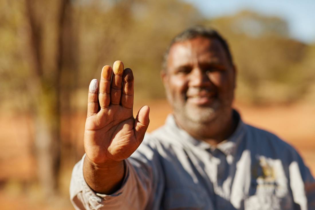 An Indigenous guide shows coloured ochres during a cultural tour | <i>Tourism NT/Matt Cherubino</i>
