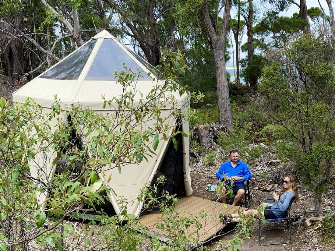 Hikers putting up their feet at our coastal Eco-Comfort Camp |  <i>Michael Buggy</i>