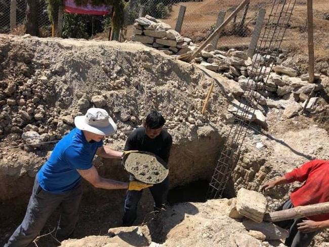 Trekkers helping to build the foundations for new classrooms in Lura village