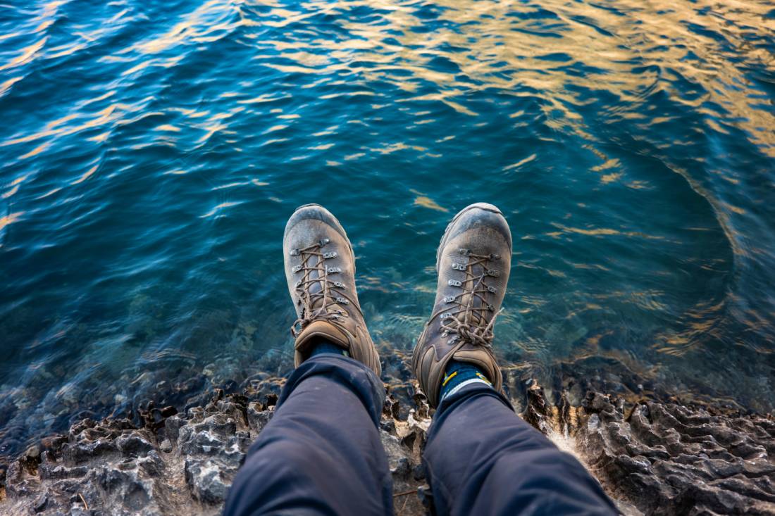 Relaxing by a lake in the Fann Mountains | Lachlan Gardiner