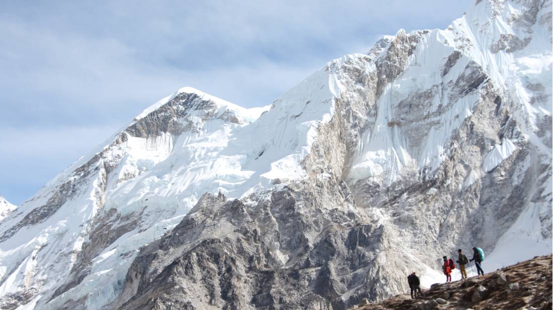Trekkers dwarfed by the mountains of the Everest Region in Nepal | <i>Ayla Rowe</i>