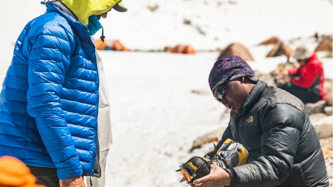 Trekkers preparing equipment before a day of climbing |  <i>Lachlan Gardiner</i>