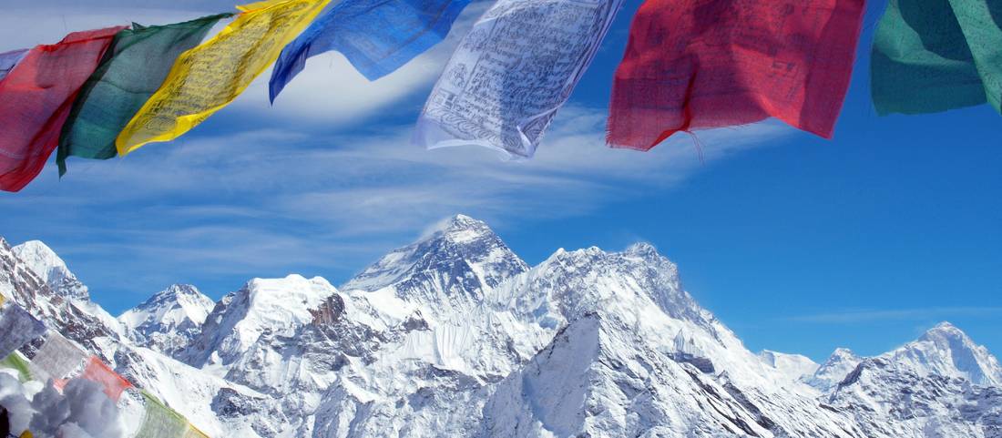 Mt Everest framed by prayer flags from the summit of Gokyo Ri | <i>Greg Bradley</i>
